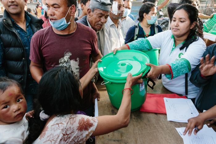 Oxfam volunteers distributing hygiene kits in Nepal