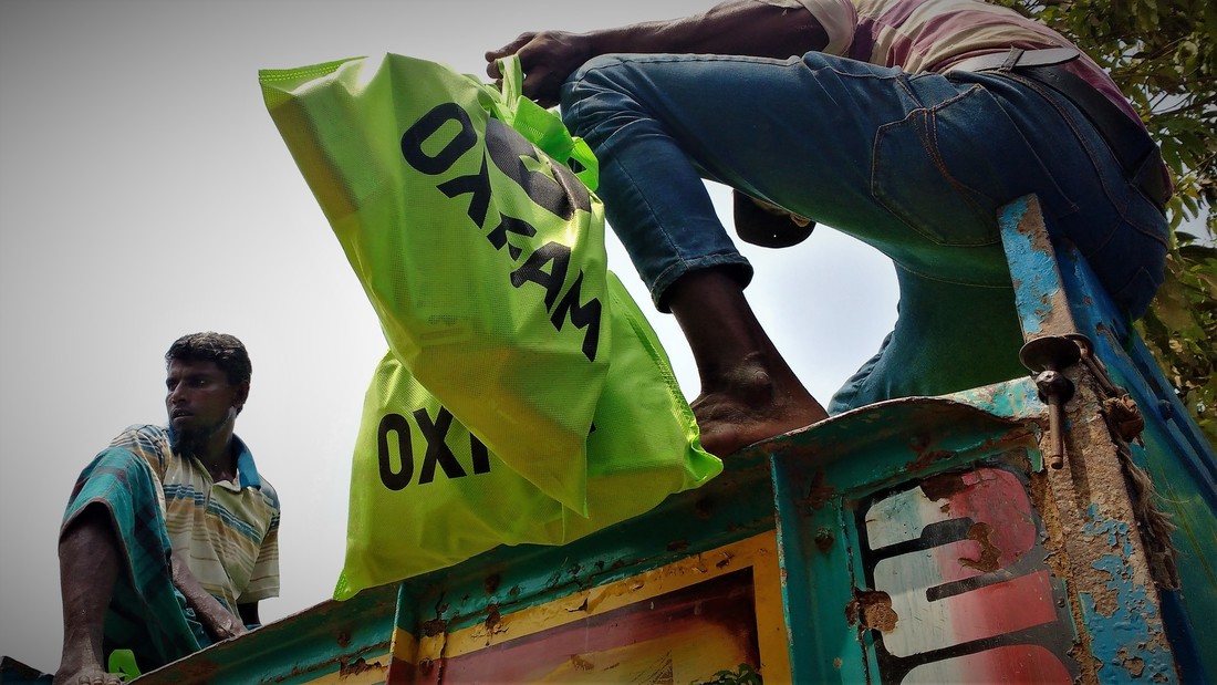 OGB_112181_Hygiene kits being unloaded from a truck before a distribution at the camp.jpg