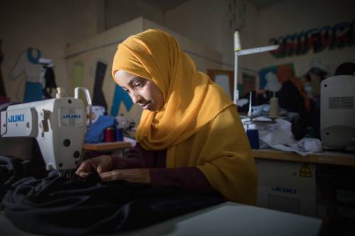 RS209406_Worker with sewing machine producing uniforms at Tayo Uniforms & Embroidery-333.jpg