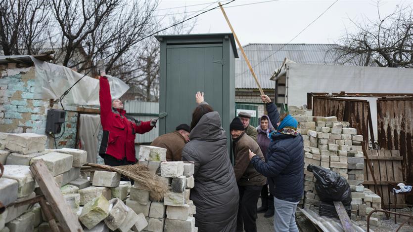 In een gemeenschap getroffen door beschietingen en bommen wordt een toilet geleverd